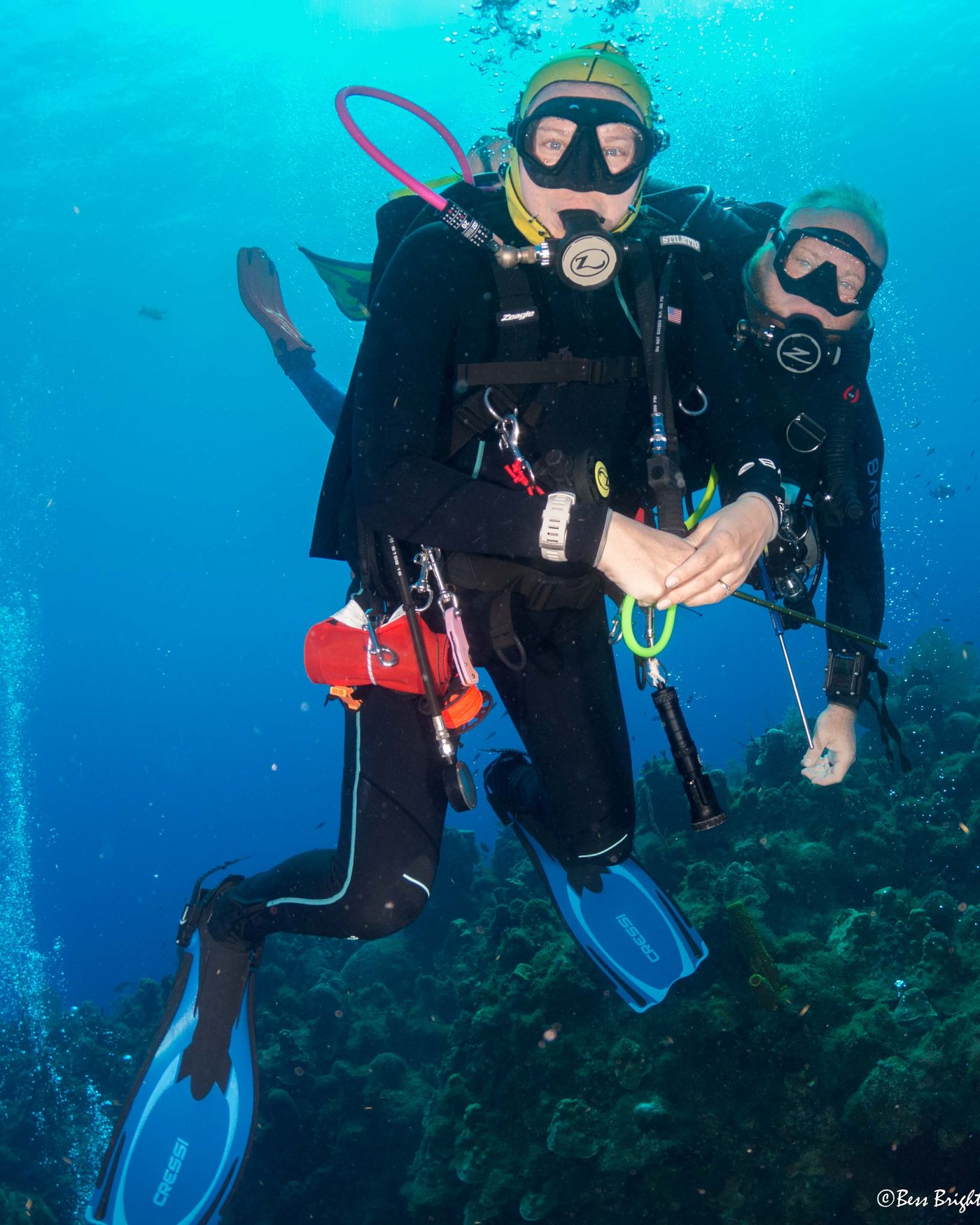 Two divers over a reef