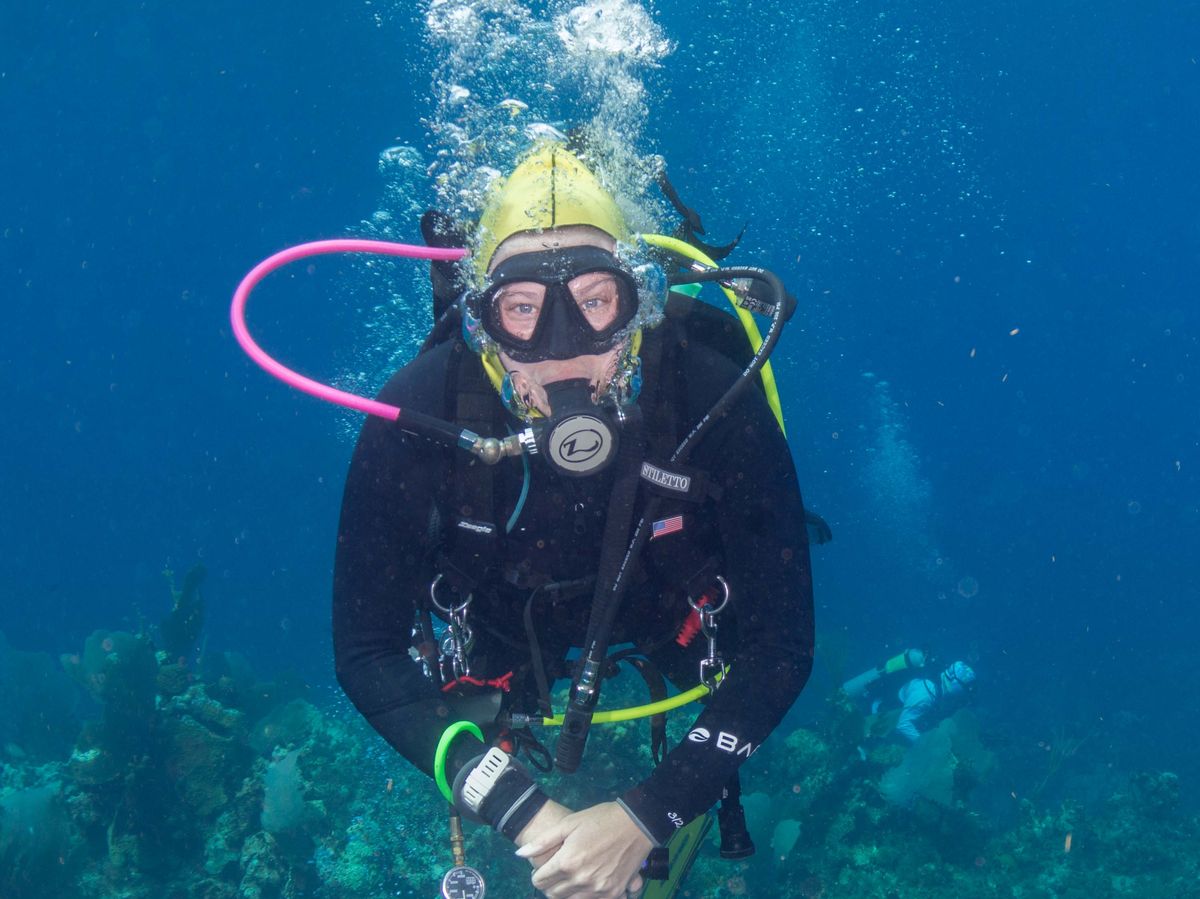 A diver descending over a coral reef