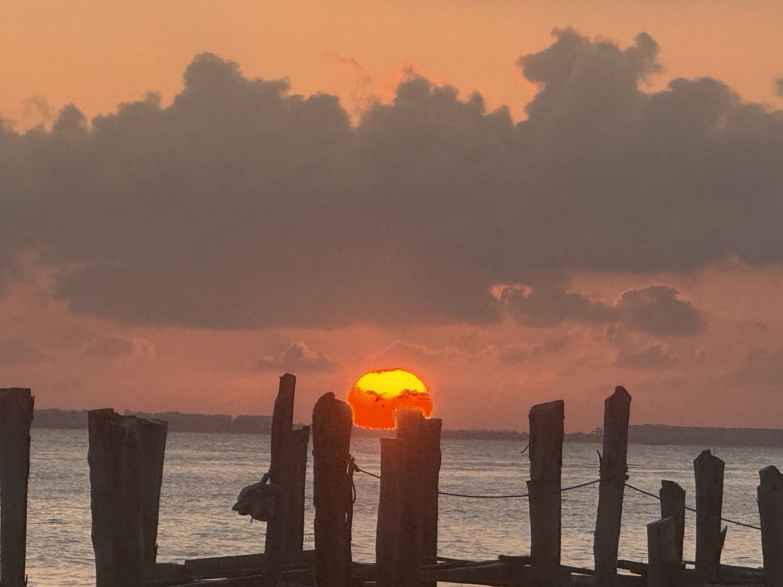 Sunset framed by pier posts